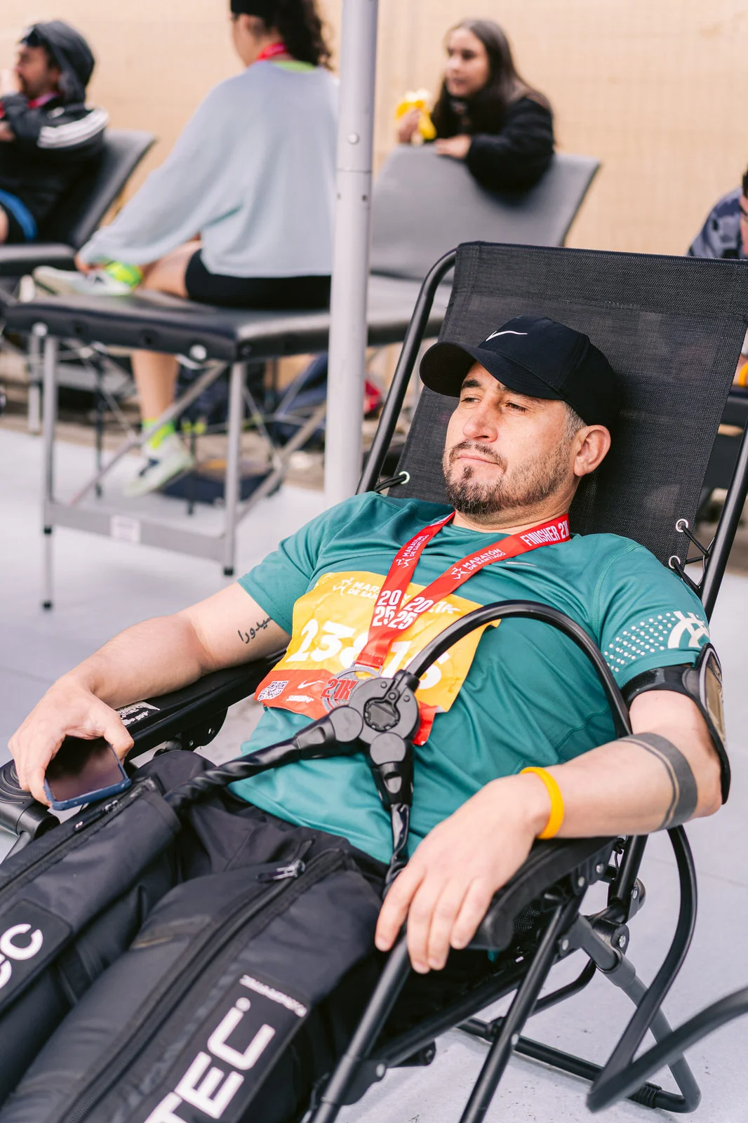 Maratón de Santiago 2025 — atleta normatec silla medalla